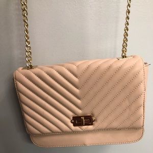 Quilted flap lock crossbody purse.